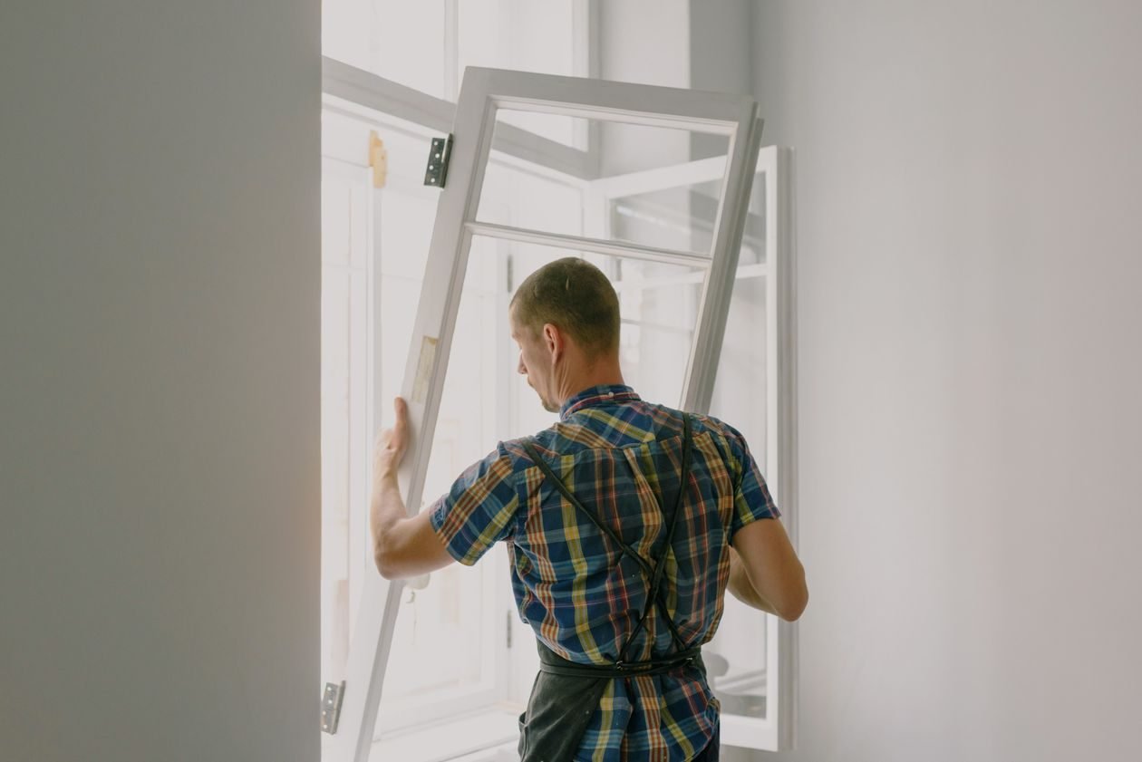 Installer fitting a new window
